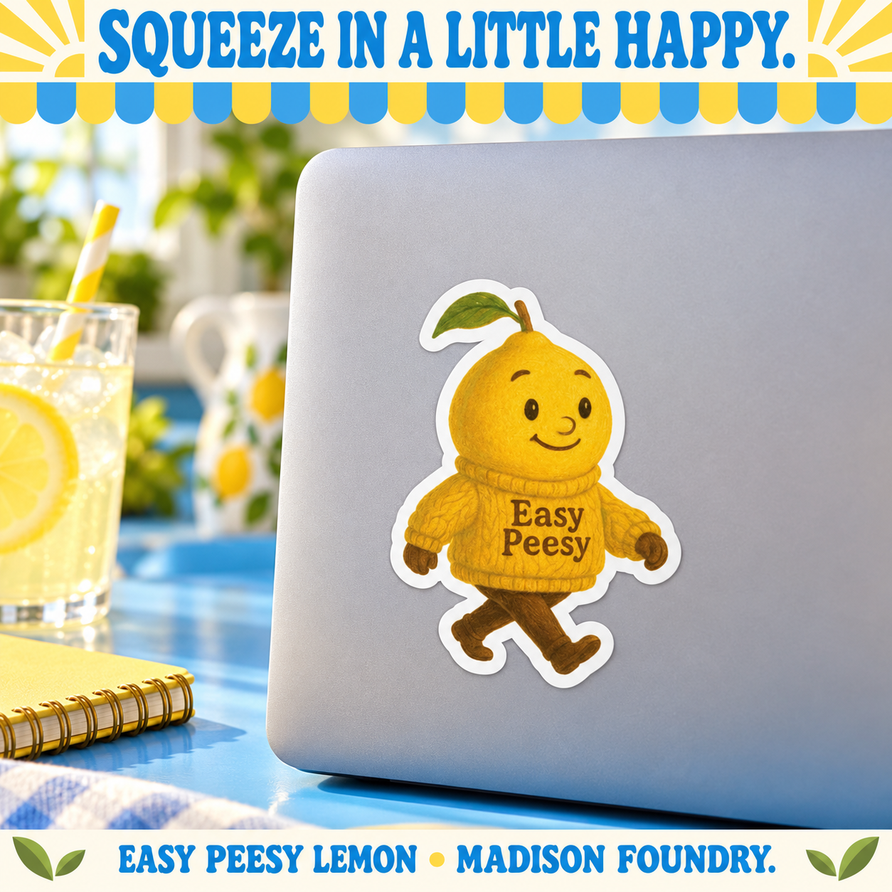 Easy Peesy lemon vinyl sticker on a plain silver laptop in a sunlit blue kitchen workspace with lemonade.