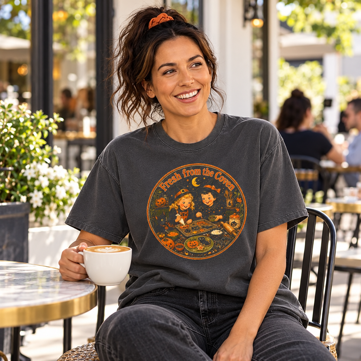 Fresh from the Coven charcoal tee — woman enjoying coffee outdoors