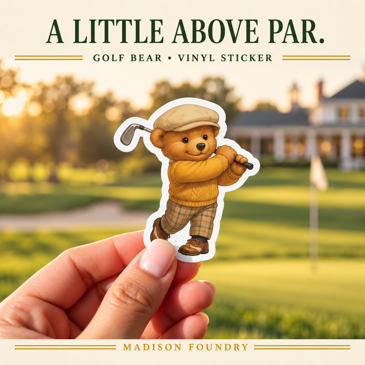 Hand-held Golf Bear vinyl sticker with flat cap, mustard sweater and plaid trousers before a sunlit golf course.
