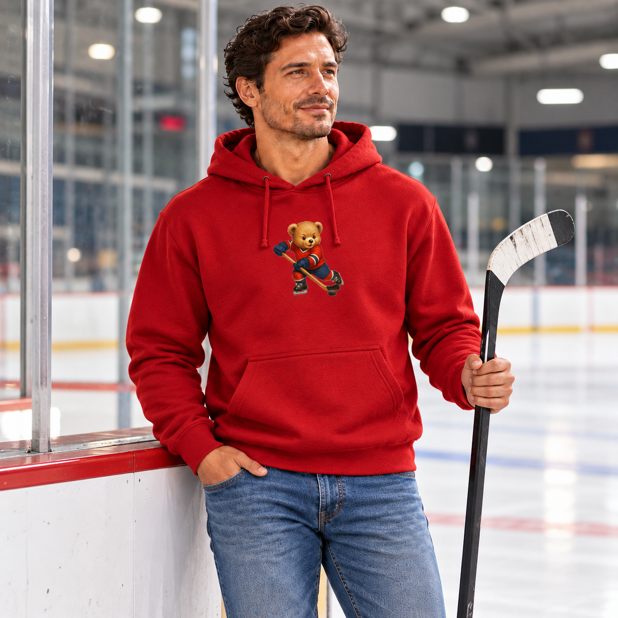 Man wearing red Hockey Bear Hoodie beside ice rink