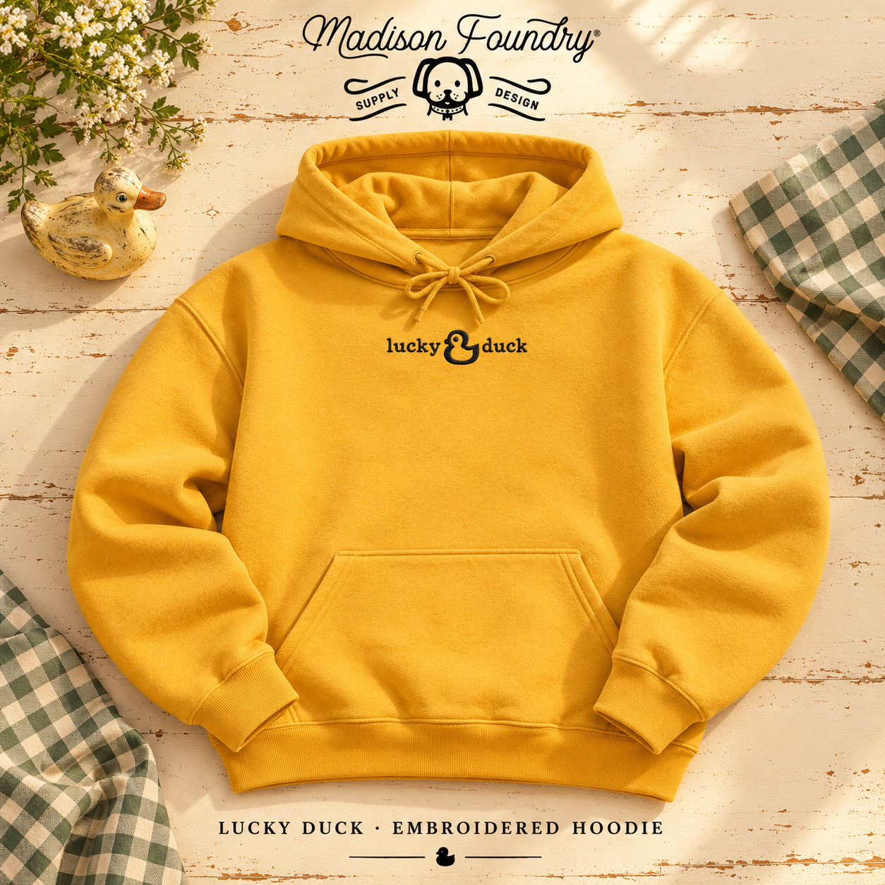Gold Lucky Duck hoodie with small black chest embroidery styled with green gingham