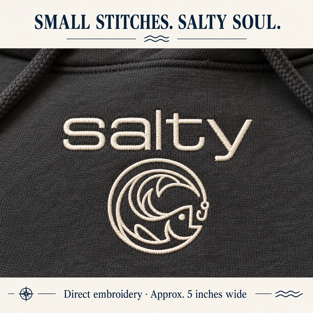 Close-up of vanilla Salty Fish embroidery on charcoal fleece