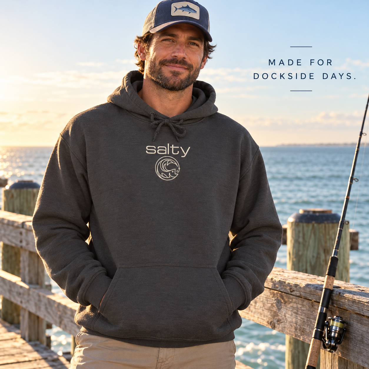Salty Fish charcoal hoodie worn on a coastal fishing pier