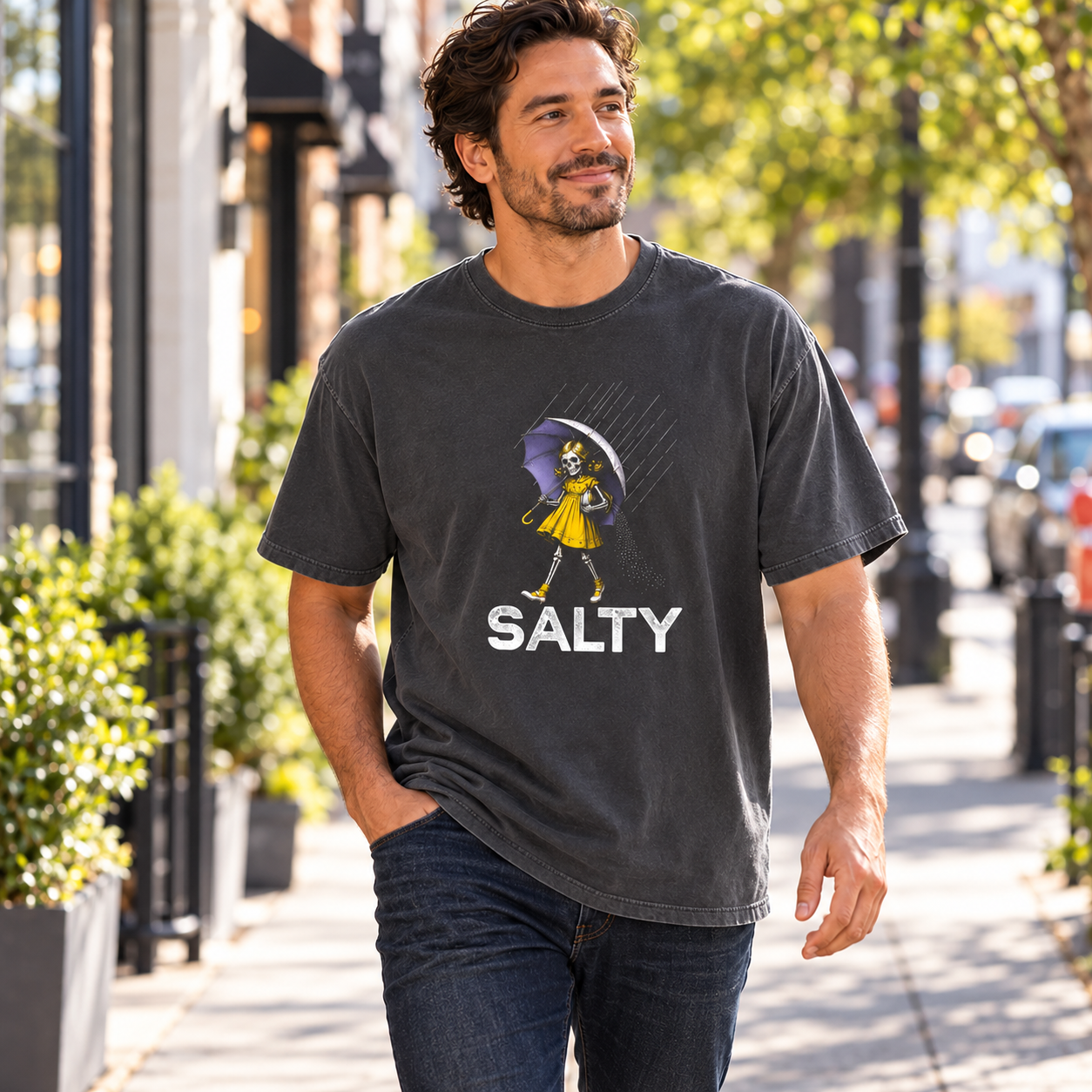 Salty Skeleton Umbrella tee — man walking along a sunny sidewalk