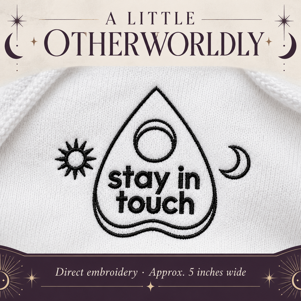 Close-up of black Stay in Touch planchette embroidery on white fleece